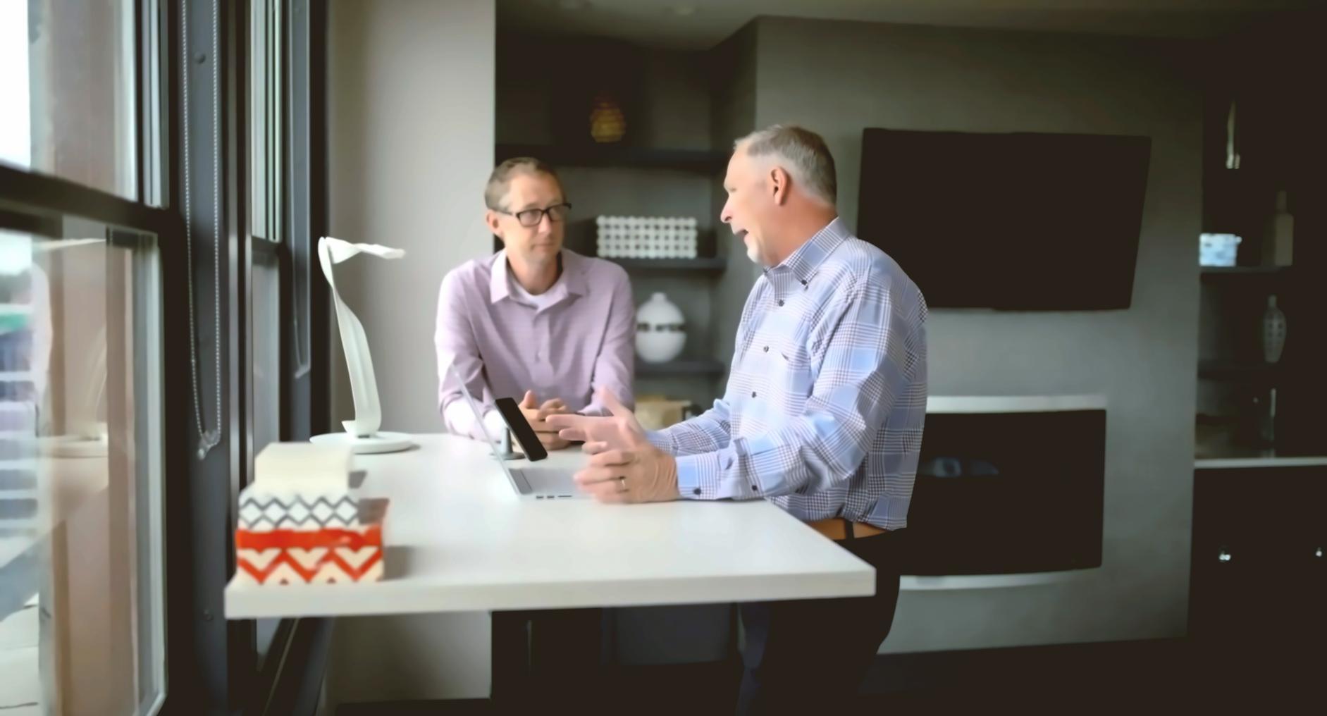 Business planning workshop with participants reviewing financial documents and charts